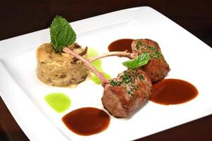 grilled lamb with dried mushroom risotto and rust sauce photo