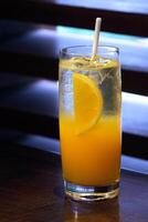 Screwdriver, drink with vodka, orange juice and ice in glass photo