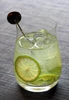 Lemon Caipiroska, classic Brazilian cocktail with vodka, lemon juice, sugar and ice photo