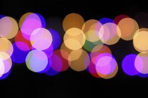 colorful and defocused lights on black background photo