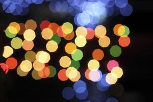 colorful and defocused lights on black background photo