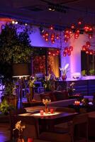 sophisticated party decoration with candles, flowers, tables and specialized lighting photo