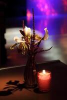 sophisticated party decoration with candles, flowers, tables and specialized lighting photo