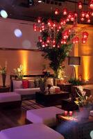 sophisticated party decoration with candles, flowers, tables and specialized lighting photo