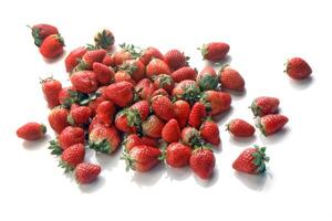 whole strawberries seen from above on white background photo