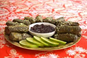 grape leaf cigars stuffed with meat accompanied by grape jelly photo