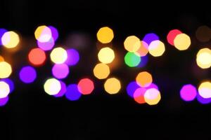 colorful and defocused lights on black background photo