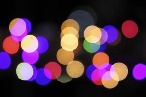 colorful and defocused lights on black background photo