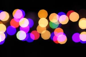 colorful and defocused lights on black background photo