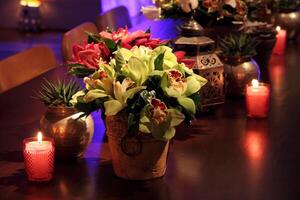 sophisticated party decoration with candles, flowers, tables and specialized lighting photo
