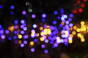 colorful and defocused lights on black background photo