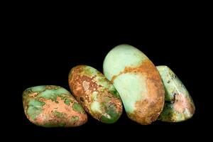 cut and rough precious stones on a black background photo