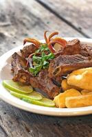 pork ribs with fried cassava and lemon photo