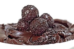 chocolate brigadeiro on plate with chocolate sprinkles photo