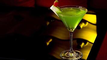 Apple Martini with green apple on the bar table photo