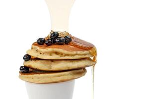 pancakes with blueberry and honey on white background photo