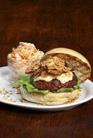 Burger with meat, cheese, lettuce, tomato and onion with a little ketchup. Typical American cuisine photo