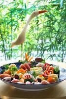 sushi and sashimi on plate in japanese restaurant photo