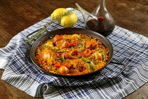 Paella Valenciana with seafood, rabbit meat, chicken, rice and saffron photo