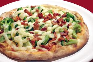 broccoli pizza with cottage cheese and bacon pieces photo