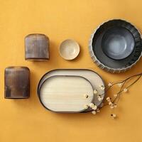 assembly of wooden cups, plates and platters with various fruits and vegetables seen from above photo