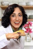 smiling brunette model with her piece of pizza photo