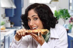 smiling brunette model with her piece of pizza photo