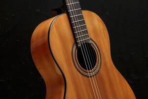 six string guitar close up on black background photo