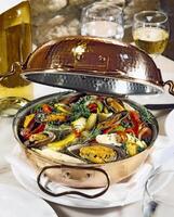 mussels, seafood and vegetables served in a cataplana. classic dish of Portuguese cuisine photo