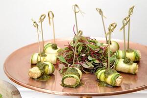 cucumber rolls with cheese and pesto sauce photo