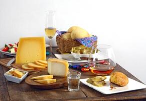 wooden table with snacks, fruits and cheeses to be tasted with pinga, the famous Brazilian brandy photo