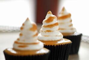 delicious cupcake with dulce de leche filling and whipped cream topping with caramel photo