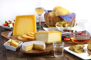 wooden table with snacks, fruits and cheeses to be tasted with pinga, the famous Brazilian brandy photo