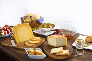 wooden table with snacks, fruits and cheeses to be tasted with pinga, the famous Brazilian brandy photo