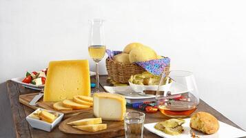 wooden table with snacks, fruits and cheeses to be tasted with pinga, the famous Brazilian brandy photo