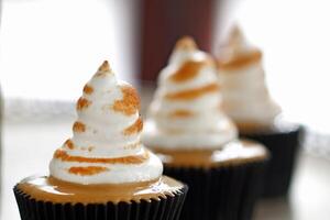 delicious cupcake with dulce de leche filling and whipped cream topping with caramel photo