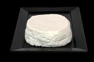 Fresh buffalo milk cheese on a black plate photo