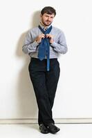 young man with beard in different situations on neutral background photo