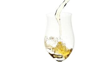 white wine being served in a glass on a white background photo