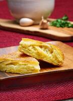 step by step of Tortilla de Patata, classic Spanish dish with eggs, potatoes, chopped chives and salt photo