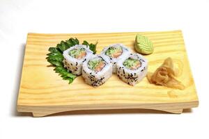 Traditional Uramaki, Japanese delicacy with nori, sesame, rice vinegar, kani kama and Japanese cucumber photo