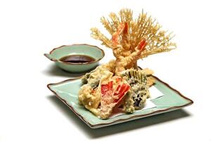 Shrimp and vegetable tempura, typical Japanese dish with breaded and fried shrimp and vegetables photo