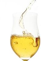 white wine being served in a glass on a white background photo