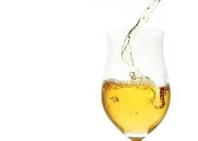 white wine being served in a glass on a white background photo