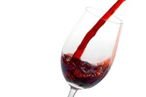 red wine being served in a glass on a white background photo