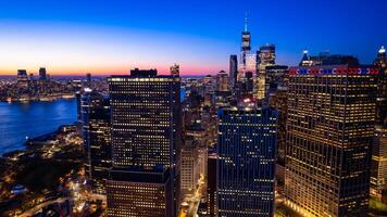 Beautiful city view with multiple lights on. New York panorama from drone photo above the East River. Aerial view.