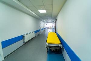 View from above on gurney or emergency bed in empty corridor of a new clinic or hospital. Closeup. photo