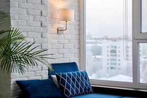 Modern loft apartment with sofa and window view on cityscape. photo