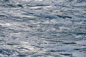 Dark foaming waves of stormy sea, background photo