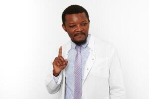 Happy black doctor man with small beard in white coat bright shirt got idea, white background photo